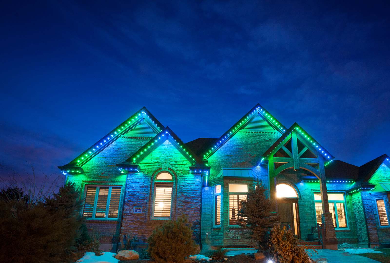 Permanent game-day outdoor lights in team colors on a residential home